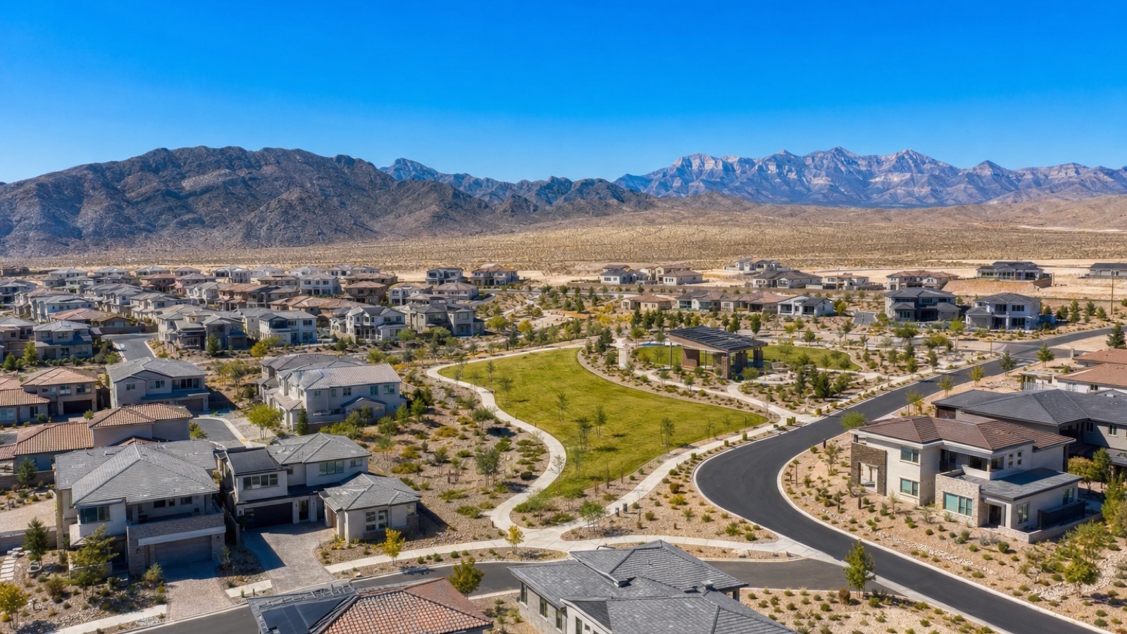 Northwest Las Vegas residential neighborhood at midday with desert landscaping and mountain backdrop