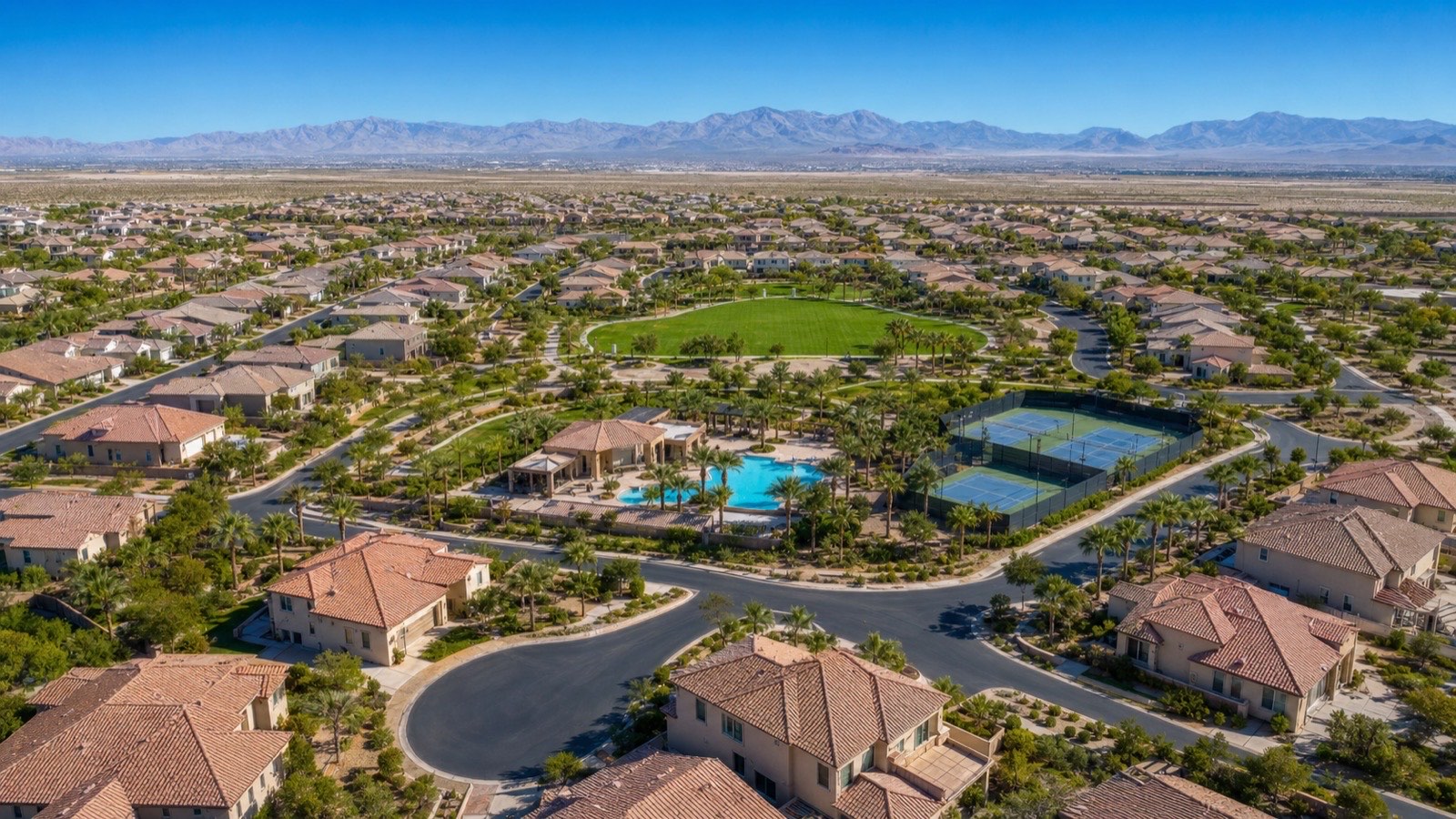 Providence Las Vegas residential streetscape at midday with manicured landscaping and tile-roof homes