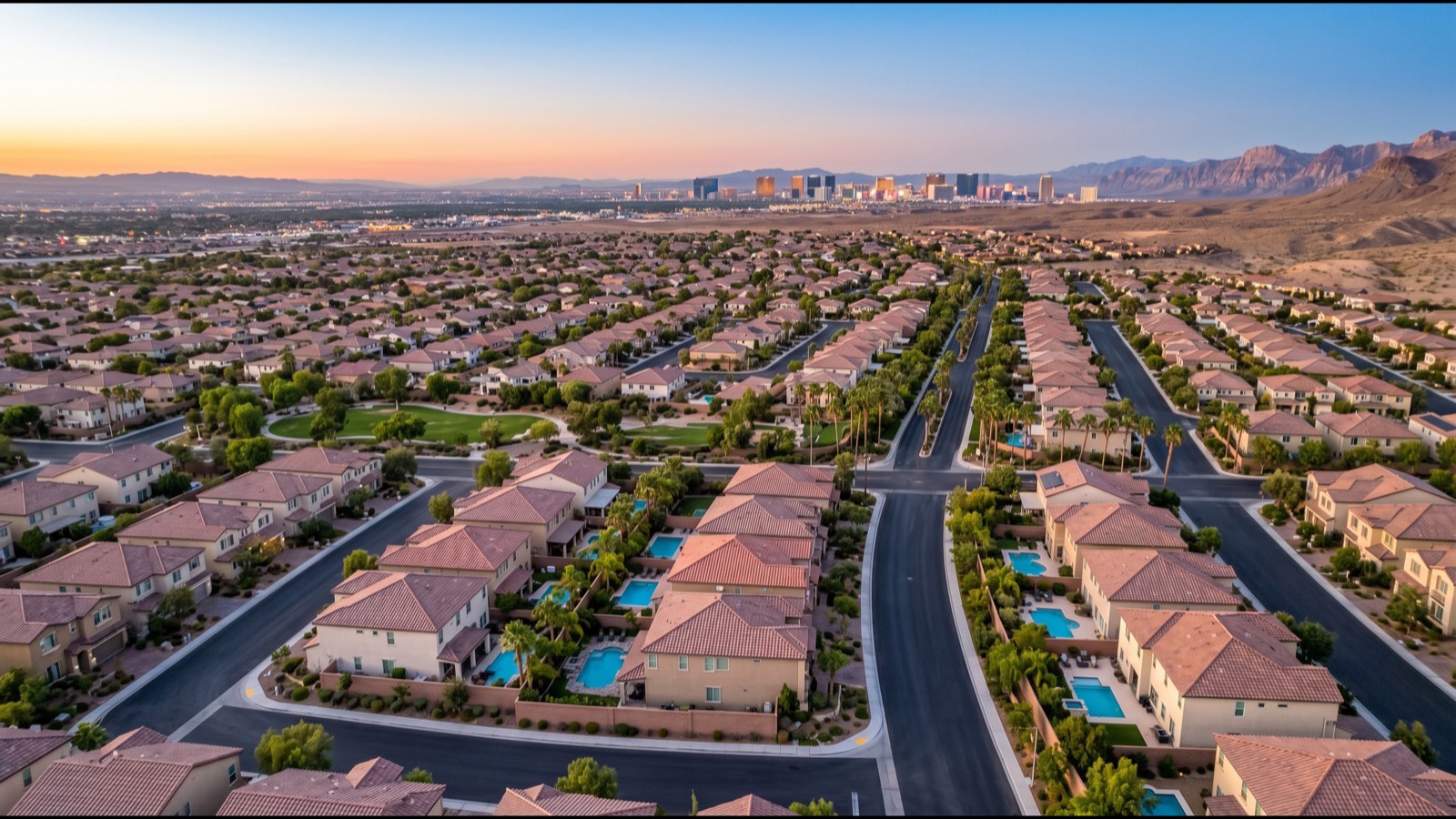 Aerial view of the Las Vegas Strip high-rise condo corridor at dusk with the resort skyline and surrounding valley